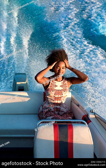 Beauty sexy afro american girl with perfect thin figure enjoying boat ride