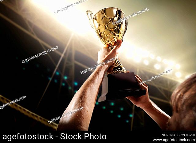 Athlete holding trophy cup
