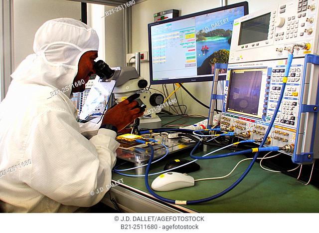 Technician Bruno Donat during hybrid adjustment procedure, manufacture of microelectronic hybrids, Thales Aleniaspace, Toulouse, Haute-Garonne, Midi-Pyrenees