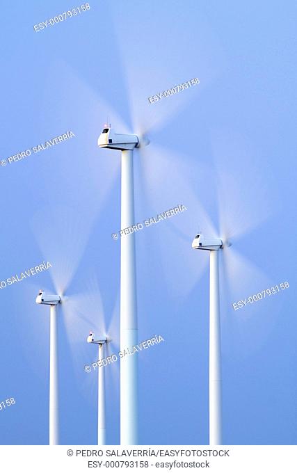 blades of a group of modern windmills turning in La Muela, Saragossa, Aragon, Spain