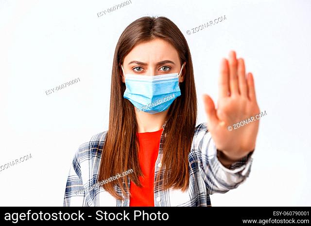 Coronavirus outbreak, leisure on quarantine, social distancing and emotions concept. Close-up of serious determined young woman want prevent or stop smth