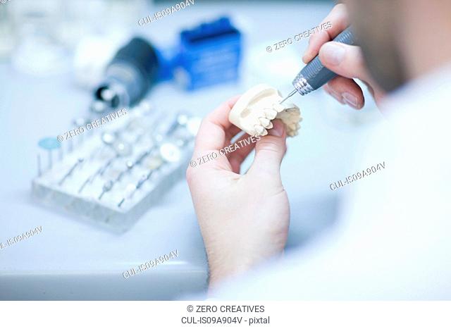 Dental technician working on denture