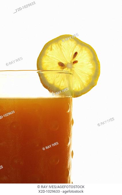 Glass of fresh fruit juice blend with a slice of lemon  Isolated  Copy space