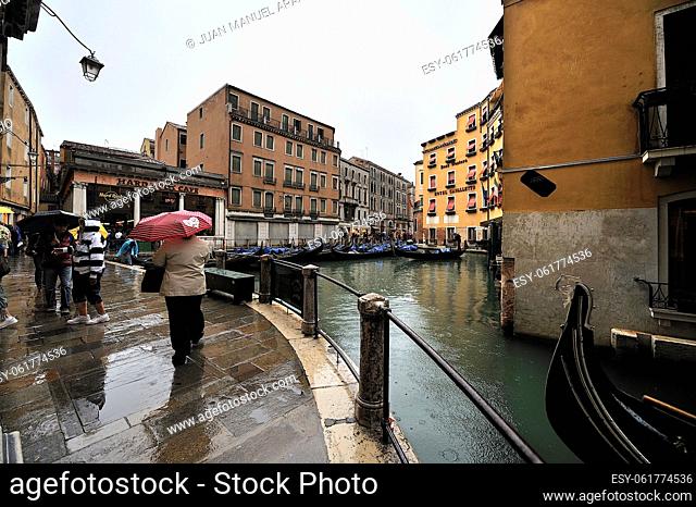 Street and small channel that leads to the Hard Rock Cafe on a rainy day in Venice, Italy