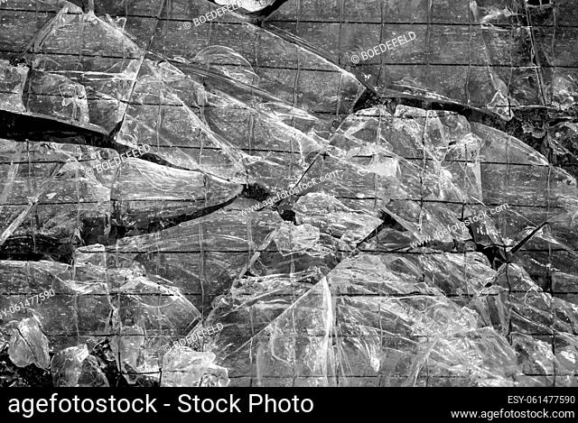 A broken glass with metal grid. Glass breakage texture