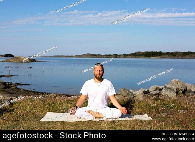 Man meditating at sea