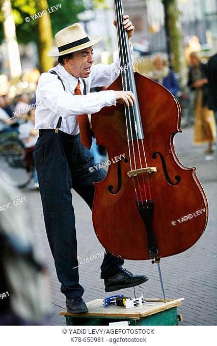 Man playing cello at Leidse Plein, Amsterdam, Holland