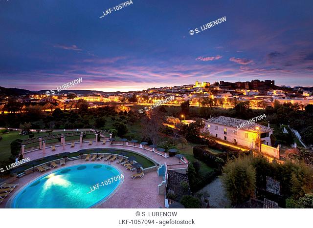 View towards old town, castle and cathedral at dusk, Silves, Algarve, Portugal