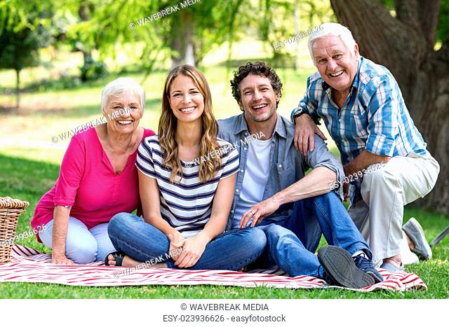 Smiling family sitting on a blanket