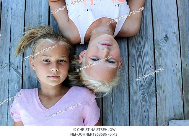 Portrait of two girls lying down