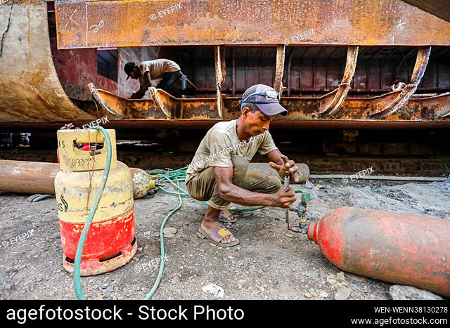 Bangladeshi workers weld a ship at a dockyard on the bank of River Buriganga, in Keraniganj, near Dhaka on 3rd September 2021