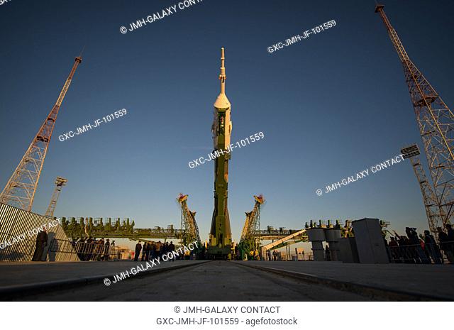 The Soyuz rocket is erected into position after being rolled out to the launch pad by train, on Sunday, October 21, 2012