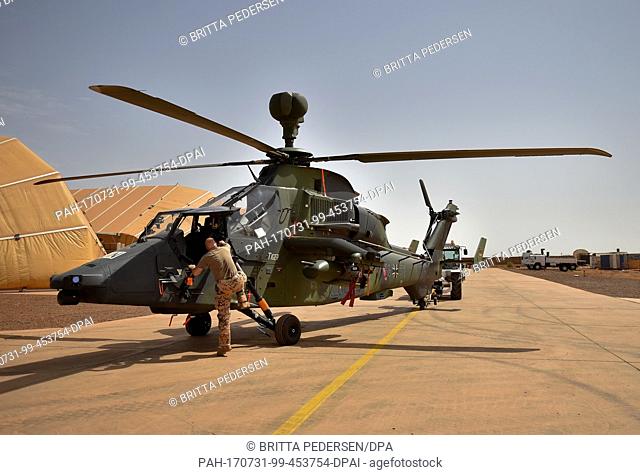 A Tiger attack helicopter is brought out of its hangar onto the airfield at Camp Castor in Gao, Mali, 30 July 2017. Photo: Britta Pedersen/dpa