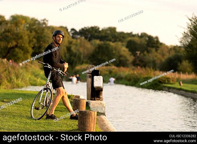 Cyclist stopping beside canal