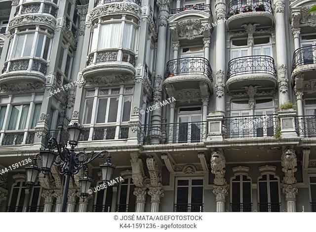 Balconies, lantern, lion, Fauns, in building facade of the city Oviedo, Asturias, Spain