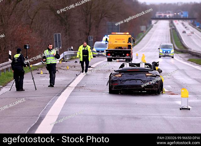 26 March 2023, North Rhine-Westphalia, Emmerich: Police officers use a 3D scanner to examine an accident scene on the A3 near Emmerich next to a demolished...