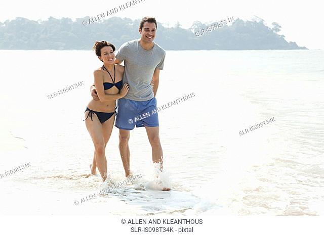 Couple walking in the sea