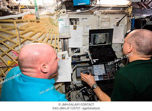 In the International Space Station's Destiny laboratory, NASA astronaut Don Pettit (right) and European Space Agency astronaut Andre Kuipers