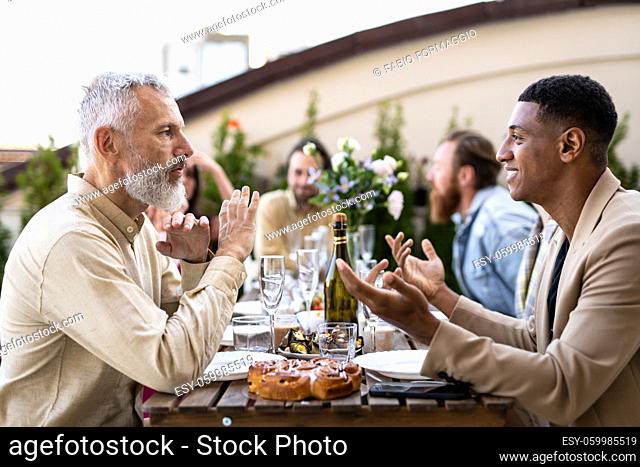 Storytelling footage of a multiethnic group of people dining on a rooftop. Family and friends make a reunion at home