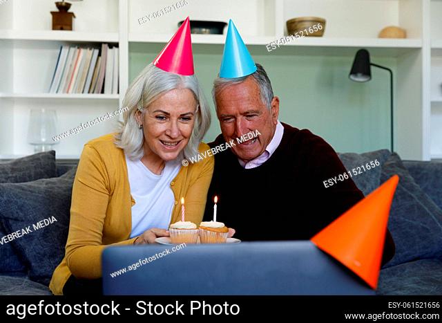 Senior caucasian couple celebrating birthday while having a video chat on laptop at home