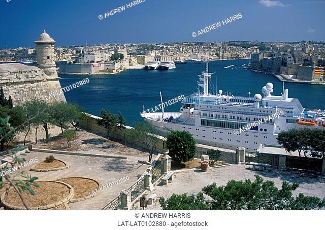 Harbour. View across bay. Cruise ship Costa Allegra moored. Historic town fortifications