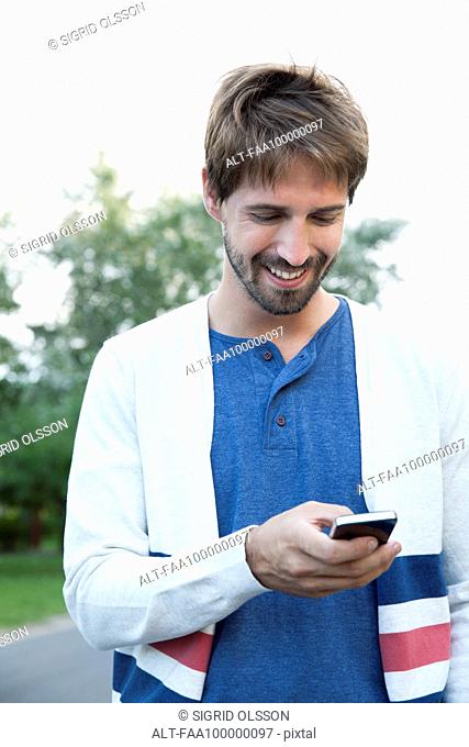 Man using smartphone outdoors