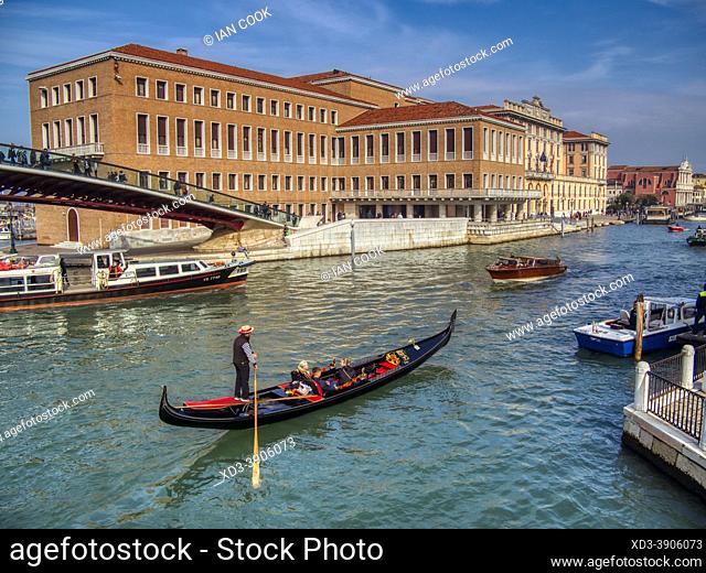 gondola beside Ponte de la Constituzione pedestrian bridge in the Grand Canal, Venice, Italy