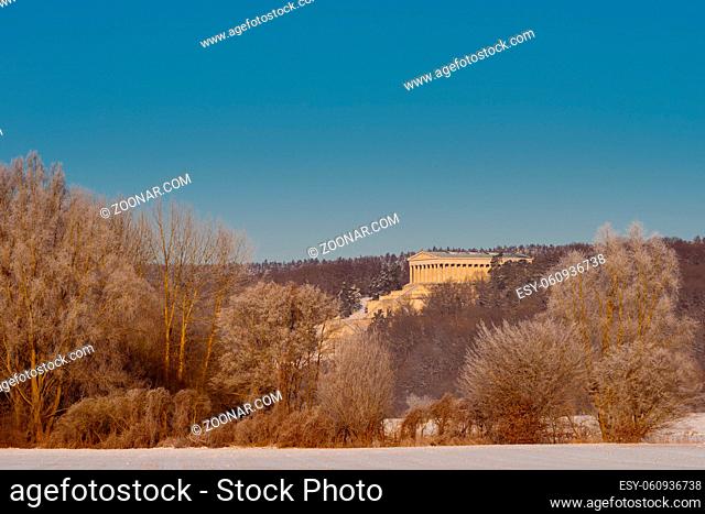 Walhalla memorial in Donaustauf near Regensburg and Danube river on clear cold winter day with sun and snow