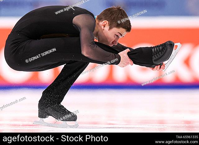 RUSSIA, CHELYABINSK - DECEMBER 21, 2023: Figure skater Grigory Fyodorov performs a sit spin during his men's short programme as part of the 2024 Russian Figure...