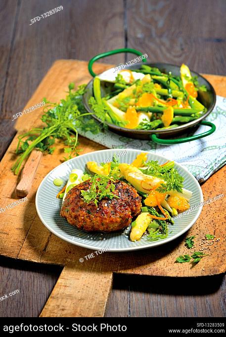 Herb fritters on an asparagus and orange salad