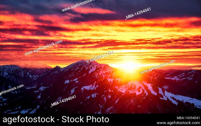 Intense sunset in the winter snowy Allgäu mountains with the Nagelfluhkette. Allgäu Alps, Bavaria, Germany