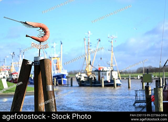 15 January 2023, Lower Saxony, Greetsiel: The precipitation of the last few days and the successive storm surges in the North Sea cause flooding in the harbor...