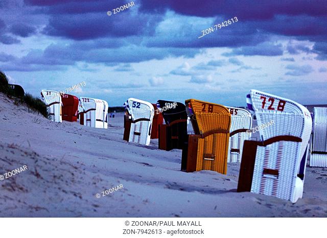 Beach windshelters chairs turned away from the wind on the Beach near Sand Dunes, northfisian island Amrum, Germany