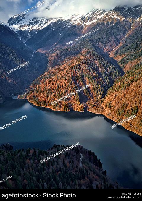 Aerial view of Lake Ritsa surrounded by forested mountains in autumn