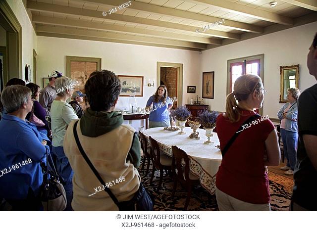 Vacherie, Louisiana - A guide talks to visitors about the restored Laura Plantation, a sugar cane plantation operated by four generations of a Creole family