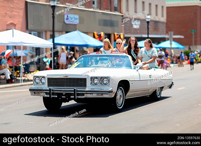 Jasper, Indiana, USA - August 5, 2018: The Strassenfest Parade, A group of Beauty queens, riding on the back of a classic car during the parade