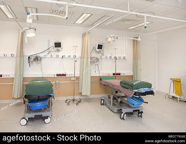 Patient faciities in a modern hospital, beds and patient bays, electronic equipment and curtains