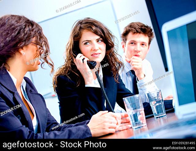 Young business people having meeting at office, businesswoman calling on phone