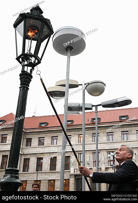 Prague Mayor Bohuslav Svoboda lights up a gas lamp at the opening of an outdoor exhibition to mark the 300th anniversary of Prague's public lighting