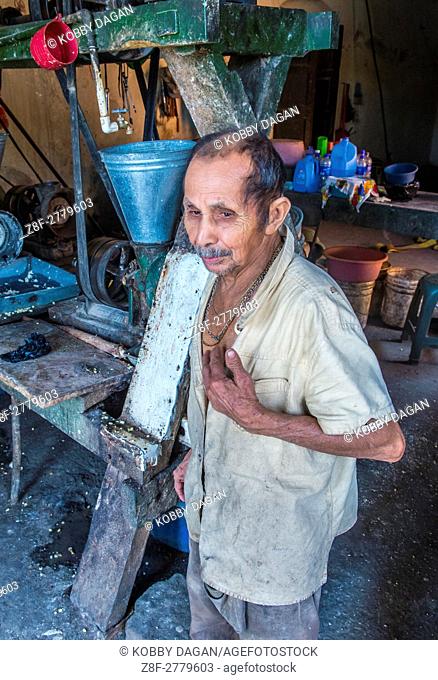 Salvadoran man work at a Corn tortilla dough factory in Suchitoto El Salvador. Corn has been a staple food in Central American cultures since pre-Columbian...