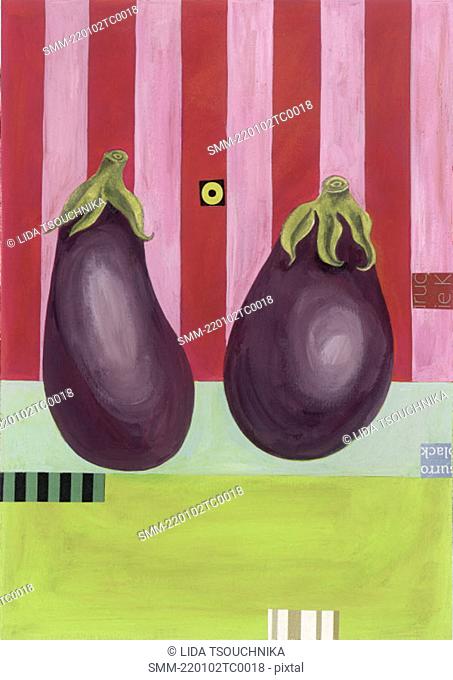 Two whole eggplants next to each other