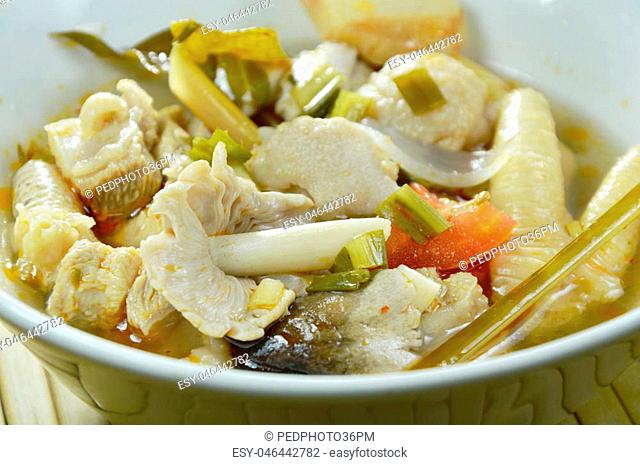 spicy boiled chicken with straw mushroom Tom Yum Soup on bowl