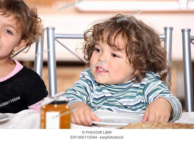 portrait of siblings having snack after school