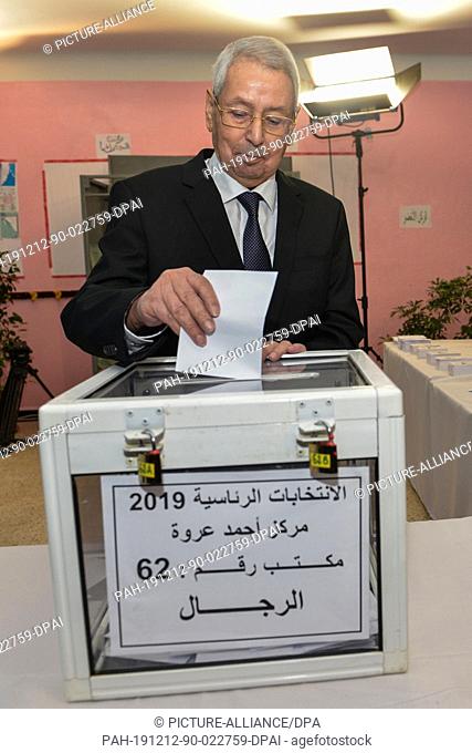 12 December 2019, Algeria, Algiers: Algerian Interim President Abdelkader Bensalah casts his vote at a polling station during the first round of the Algerian...