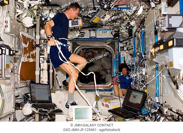 European Space Agency astronaut Paolo Nespoli, Expedition 26 flight engineer, works out on the Cycle Ergometer Vibration Isolation System (CEVIS) while NASA...