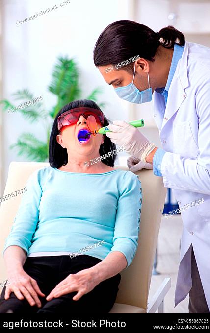 The old woman visiting young doctor dentist