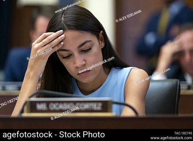 Representative Alexandria Ocasio-Cortez, D-N.Y., listens as Federal Reserve Board Chairman Jerome Powell testifies before the House Financial Services Committee...