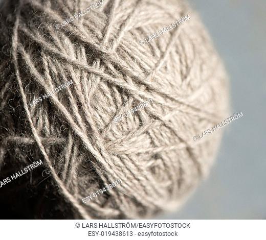 Close up of gray ball of yarn. Detail of equipment used for knitting and needlework as a hobby