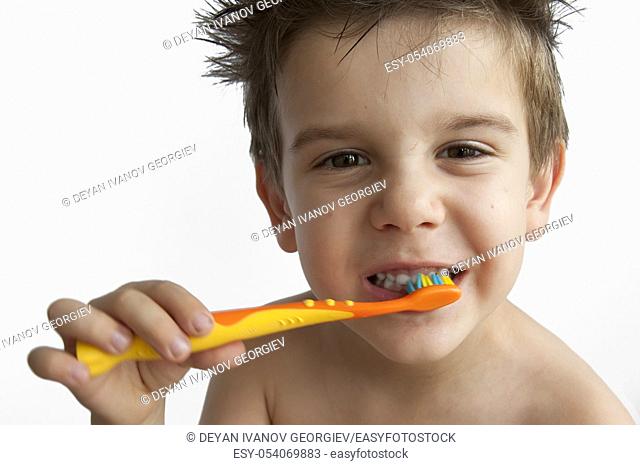 Boy washing teeth with toothbrush