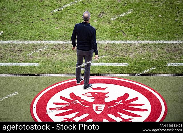 coach Adi HUETTER (Hutter) (F) photographed from behind, stands on the sideline in front of the Eintracht logo on the pitch outside the field; Soccer 1st...